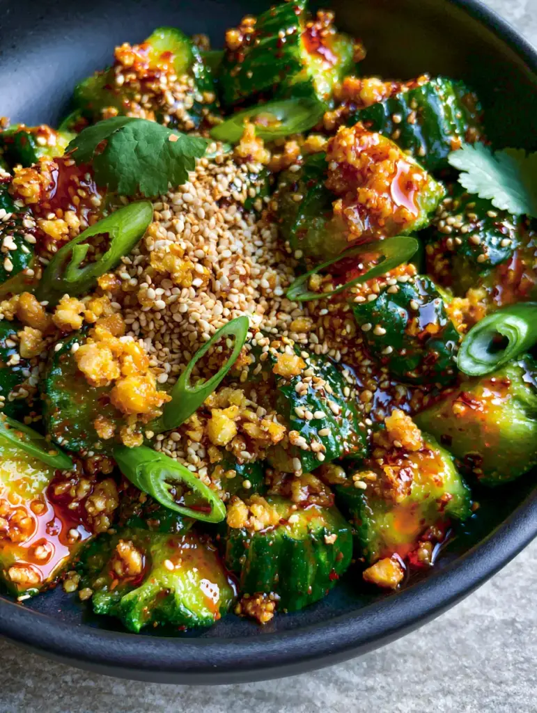 Asian Cucumber Salad with Crispy Garlic and Glossy Chili Oil 1 Top-down view of Asian Cucumber Salad highlighting green scallions and sesame seeds. (Asian Cucumber Salad)