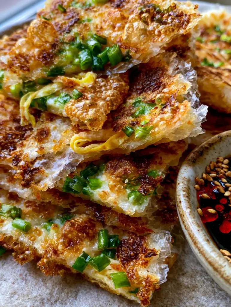 Rice Paper Scallion Pancakes: The Ultimate Shatter-Crisp Gluten-Free Shortcut 2 Extreme macro close-up of Rice Paper Scallion Pancakes highlighting the bubbled, translucent layers and bright green scallions.