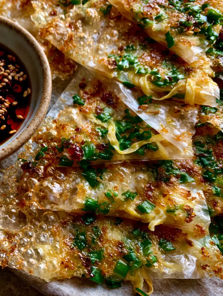 Rice Paper Scallion Pancakes: The Ultimate Shatter-Crisp Gluten-Free Shortcut 1 Overhead view of Rice Paper Scallion Pancakes with shattered crispy edges and a side of red chili oil soy sauce.