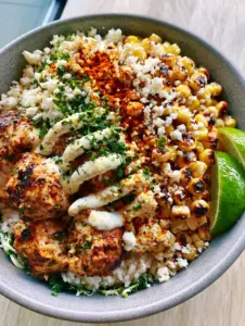Macro shot of seared cilantro lime chicken and blistered corn in a Street Corn Chicken Bowl.