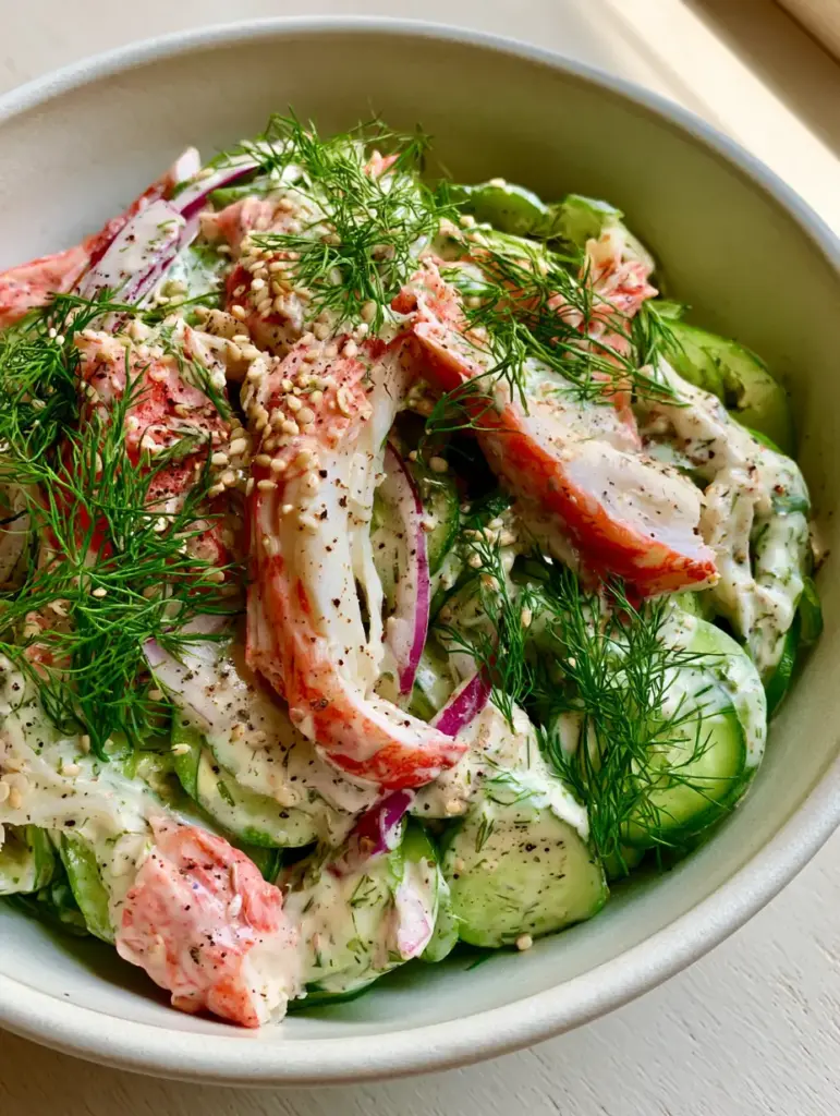 Creamy Cucumber Crab Salad: The Ultimate 15-Minute Refreshing Summer Side 1 Close-up of the meaty pink and white fibers of imitation crab mixed with bright green cucumbers and paper-thin red onions.