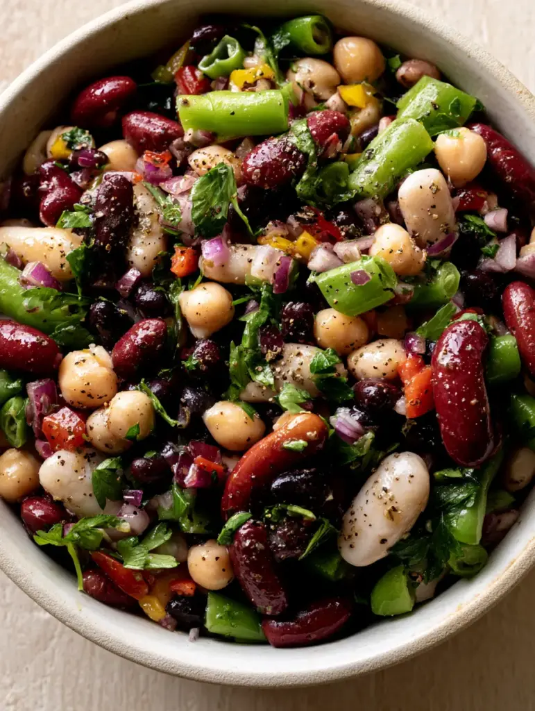 Five Bean Salad with Zesty Herb Vinaigrette 1 High-detail photo of a five bean salad highlighting the contrast between black beans and white cannellini beans.