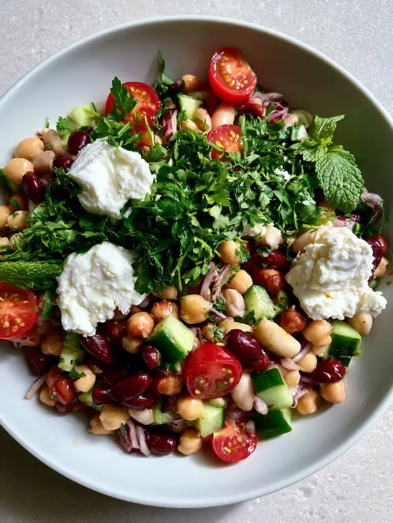 Overhead shot of 3 bean Mediterranean salad with moist feta chunks and red kidney beans.