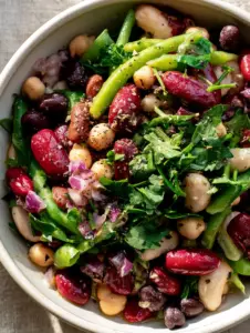 Macro shot showing the shimmering lemon-oil coating on red kidney beans and chickpeas in a 5-Bean Salad. (5-Bean Salad)