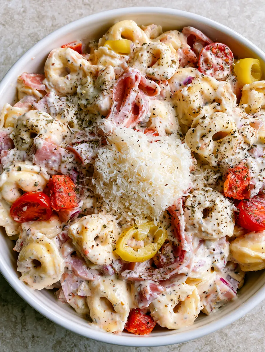 Italian Grinder Tortellini Salad with Creamy Herb Dressing 4 Close-up of Italian Grinder Tortellini Salad with thick creamy herb dressing, speckled with oregano and black pepper.