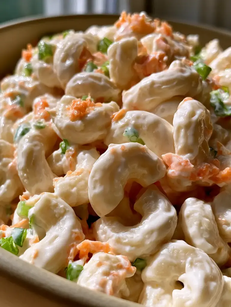 Hawaiian Macaroni Salad: The Authentic Creamy Plate Lunch Classic 1 A close-up view of Hawaiian macaroni salad highlighting the finely grated carrots and soft elbow macaroni.