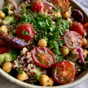 Macro close-up of fluffy mixed quinoa and plump golden chickpeas in a Mediterranean chickpea quinoa salad.