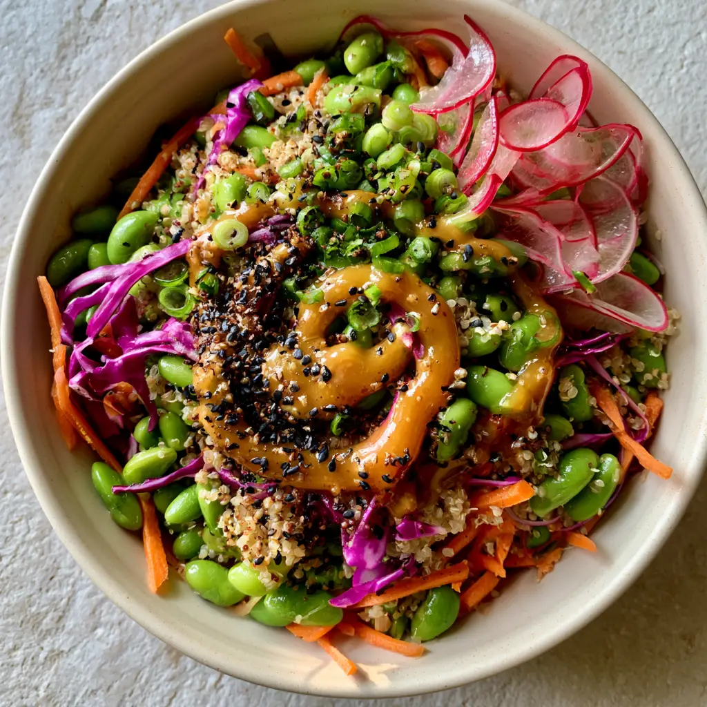 Close-up of translucent red radish slices and glossy sesame ginger dressing on an Edamame salad.